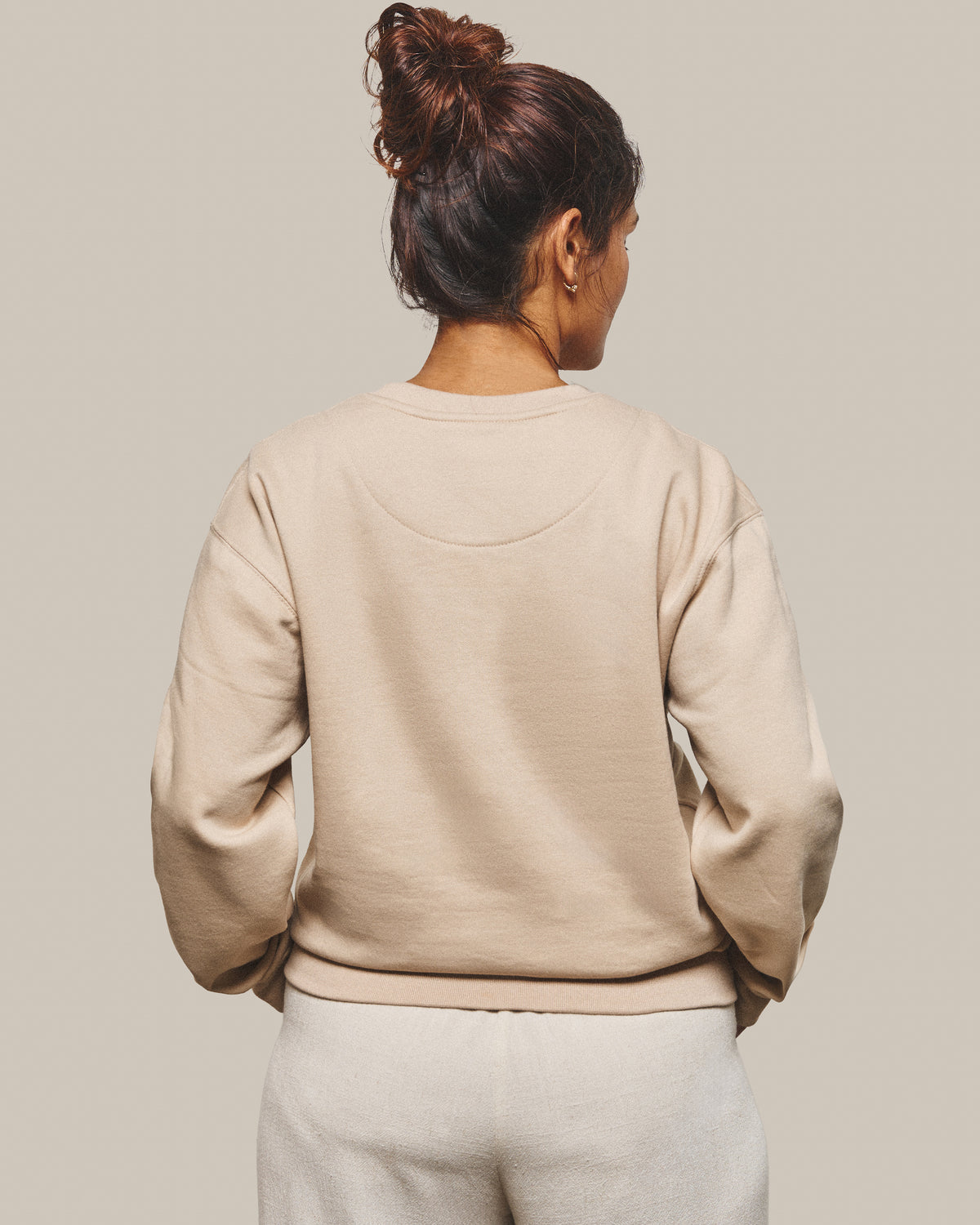 The back of the Grounded Sweatshirt in Bone, plain with no print.