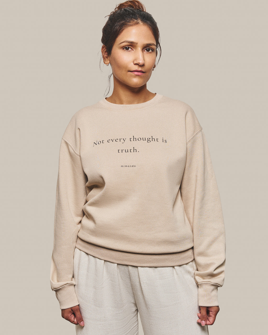 The Grounded Sweatshirt in Bone. The print reads: Not every thought is truth.