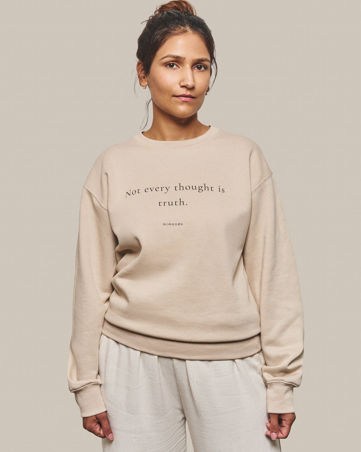 The Grounded Sweatshirt in Bone. The print reads: Not every thought is truth.