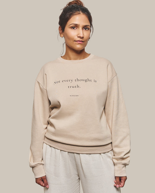 The Grounded Sweatshirt in Bone. The print reads: Not every thought is truth.