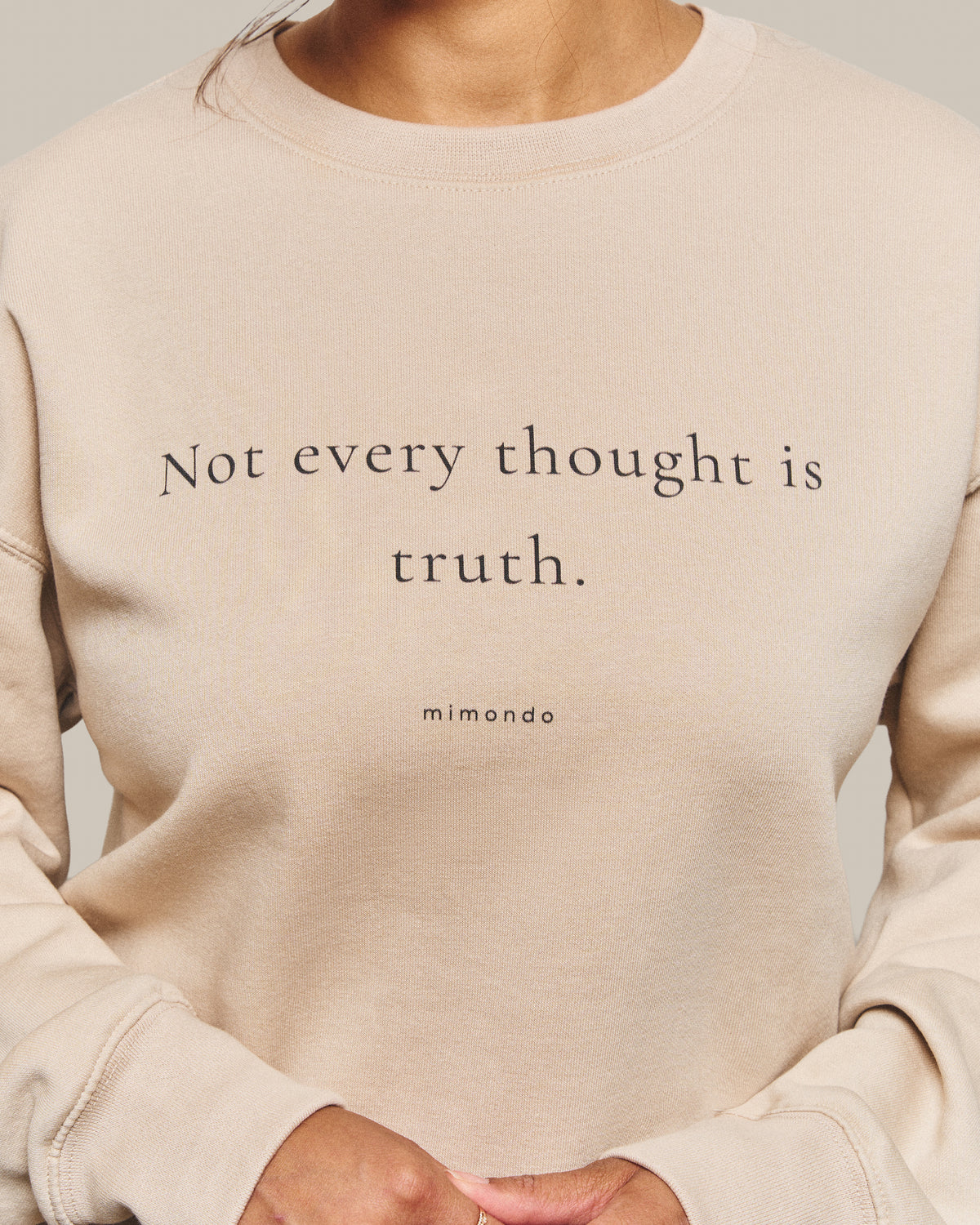 Close-up of the print on the Grounded Sweatshirt: Not every thought is truth. With mimondo printed beneath.