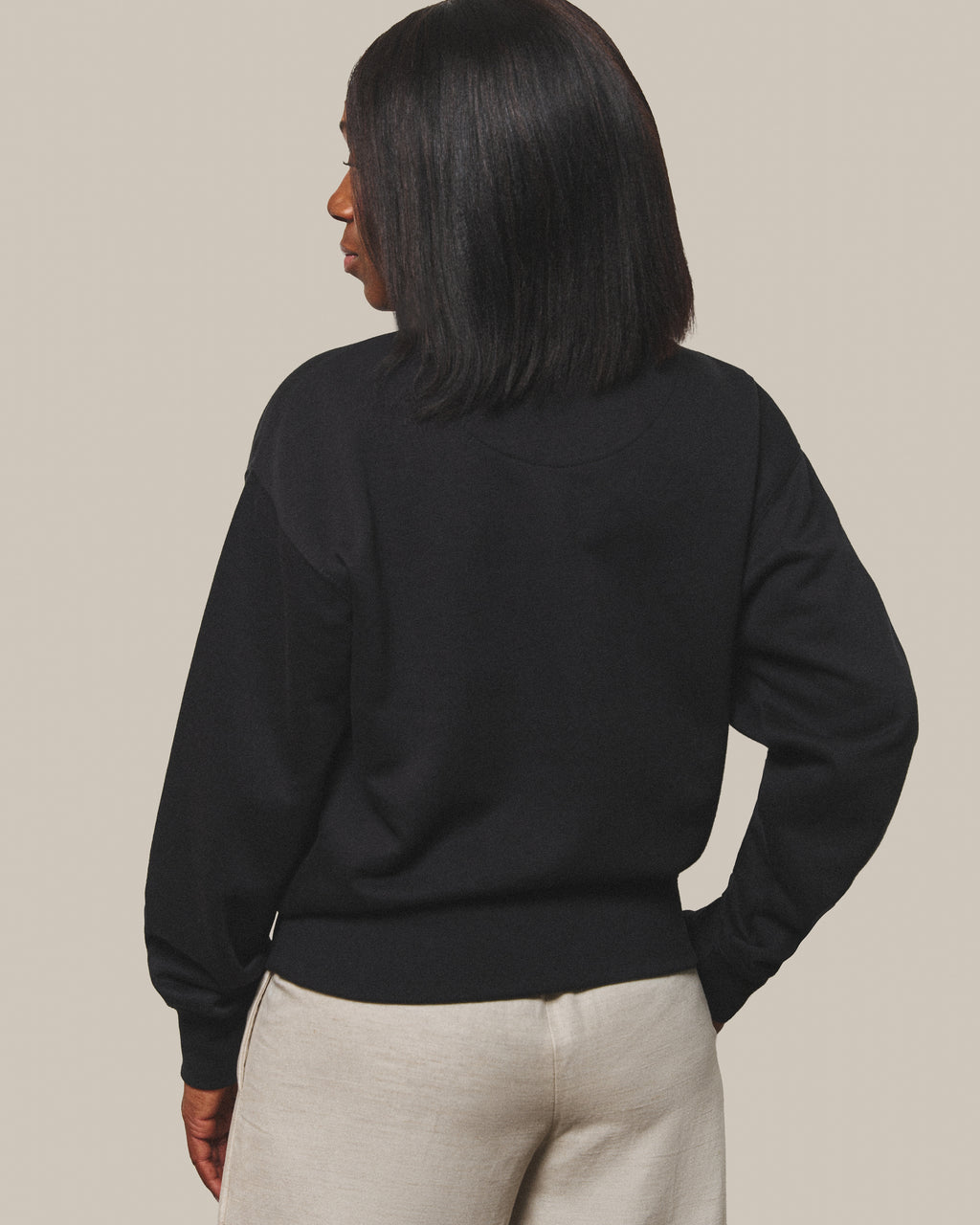 The back of the Persist Sweatshirt in Black, plain with no print.