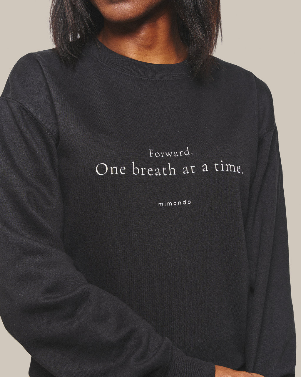 Close-up of the print on the Persist Sweatshirt: Forward. One breath at a time. With mimondo printed beneath.
