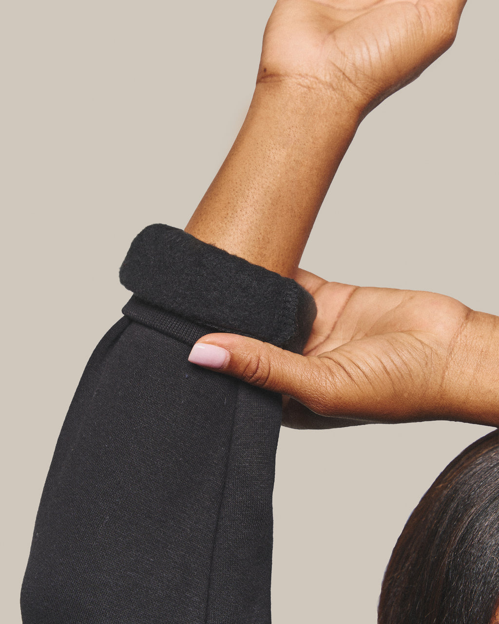 The cuff of the Persist Sweatshirt turned back to show the brushed fleece inside.