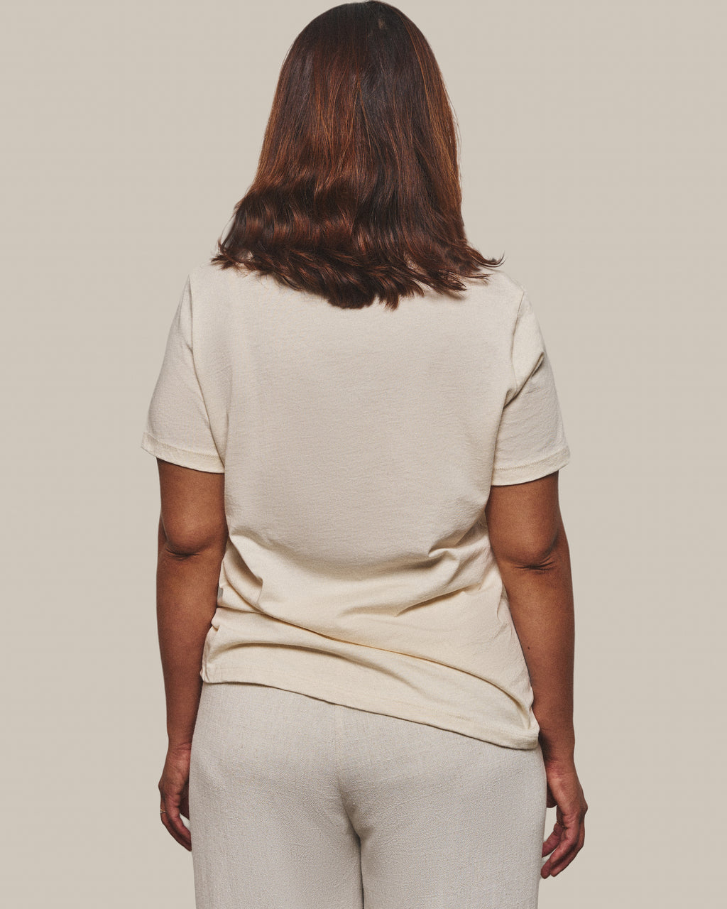 The back of the Still Tee in Warm Ivory, plain with no print.