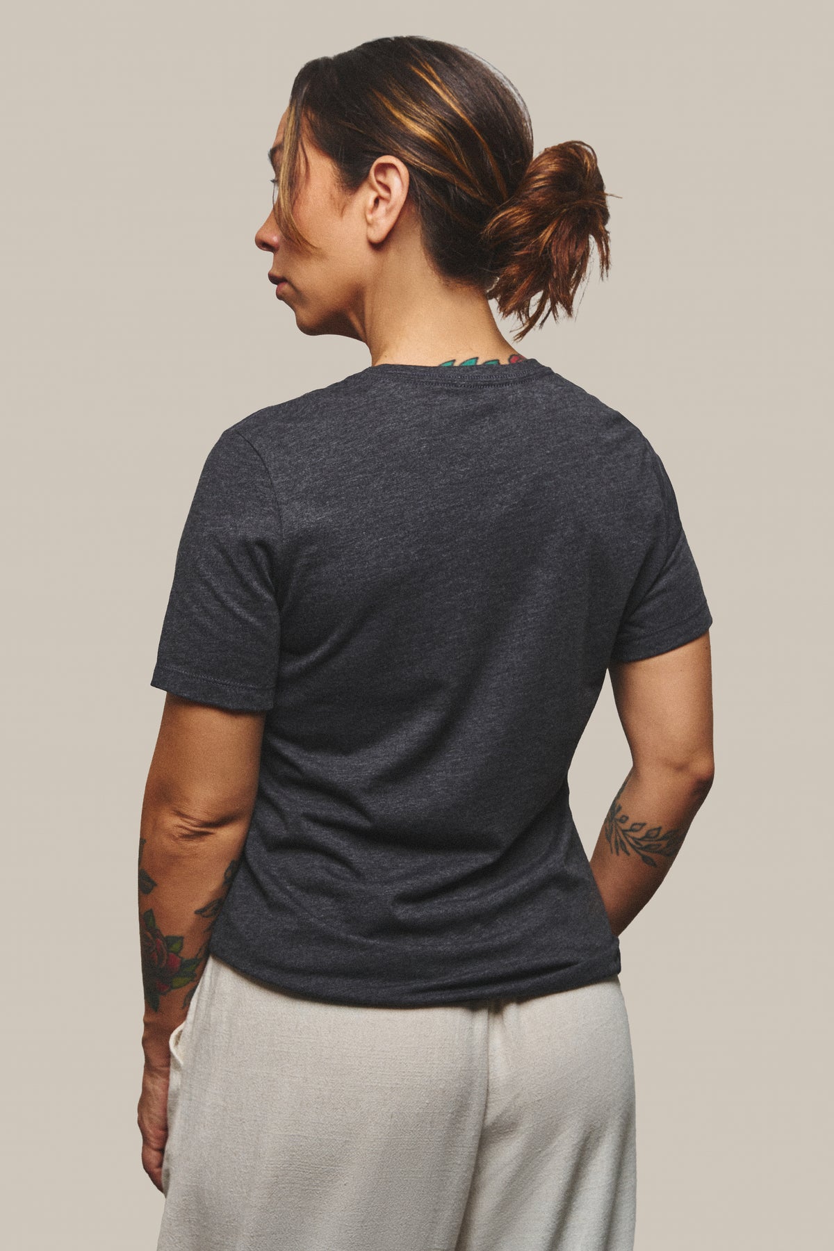 The back of the Strength Tee in Dark Grey Heather, plain with no print.
